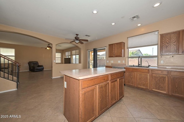 16112 W Durango St, Goodyear, AZ 85338 - kitchen featuring a sink, arched walkways, a ceiling fan, light tile patterned floors, and visible vents