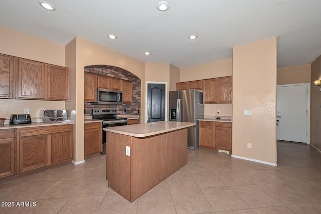 16112 W Durango St, Goodyear, AZ 85338 - kitchen with light countertops, appliances with stainless steel finishes, and brown cabinetry