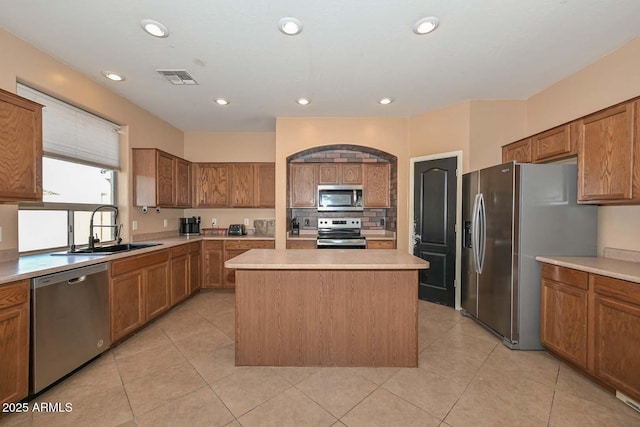 16112 W Durango St, Goodyear, AZ 85338 - kitchen with brown cabinetry, visible vents, a center island, a sink, and appliances with stainless steel finishes