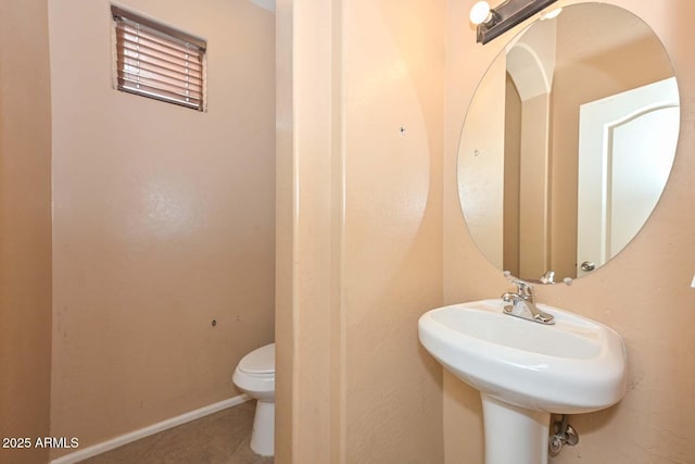 16112 W Durango St, Goodyear, AZ 85338 - bathroom with a sink, baseboards, tile patterned flooring, and toilet