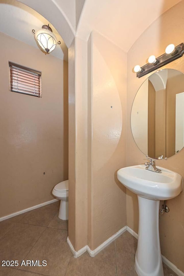 16112 W Durango St, Goodyear, AZ 85338 - bathroom with baseboards, tile patterned floors, and toilet
