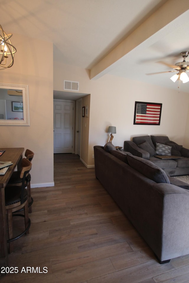 living area featuring baseboards, ceiling fan with notable chandelier, wood finished floors, and visible vents