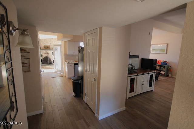 hallway with baseboards and dark wood finished floors