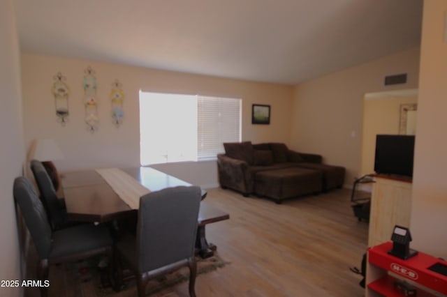 dining area featuring visible vents and wood finished floors