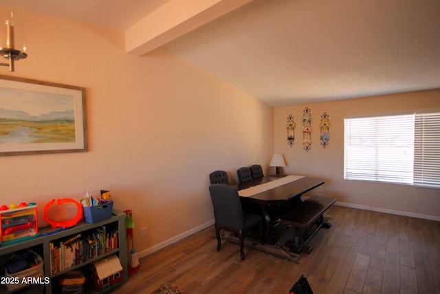 dining room with baseboards, lofted ceiling with beams, and wood finished floors
