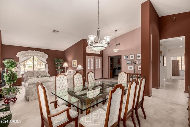 dining room with high vaulted ceiling, light tile patterned floors, and a notable chandelier