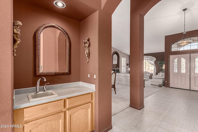 bathroom featuring vanity and lofted ceiling