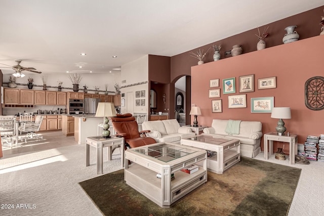 carpeted living room featuring ceiling fan