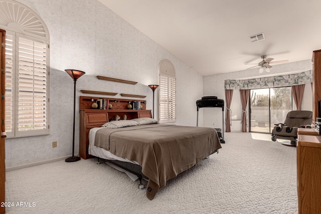 carpeted bedroom with access to outside, vaulted ceiling, and ceiling fan