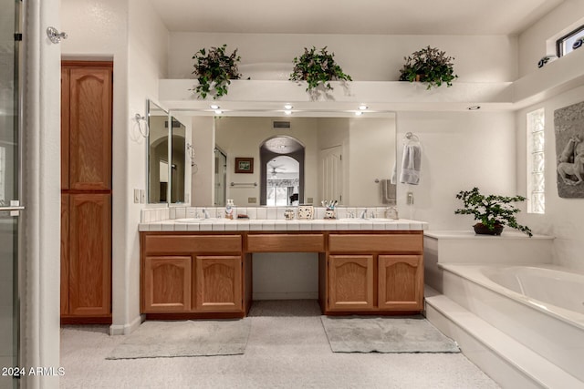 bathroom with a washtub and vanity