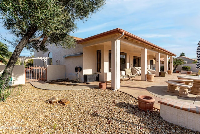 back of property with a patio area