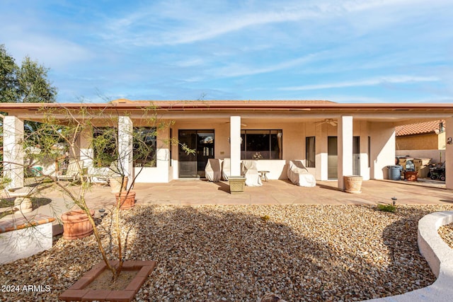 back of property featuring ceiling fan and a patio