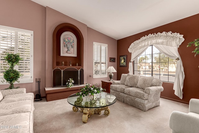 carpeted living room featuring lofted ceiling