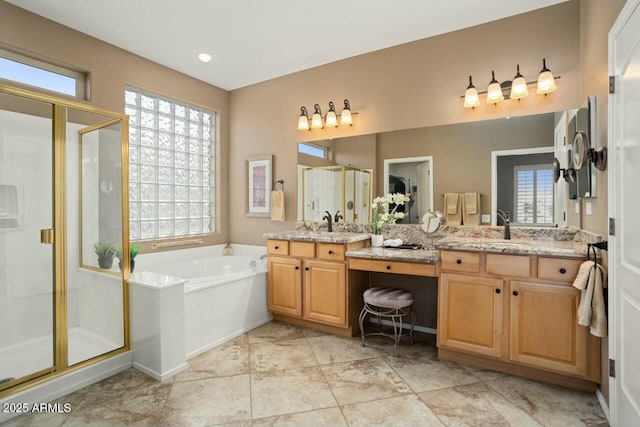 bathroom with vanity and shower with separate bathtub