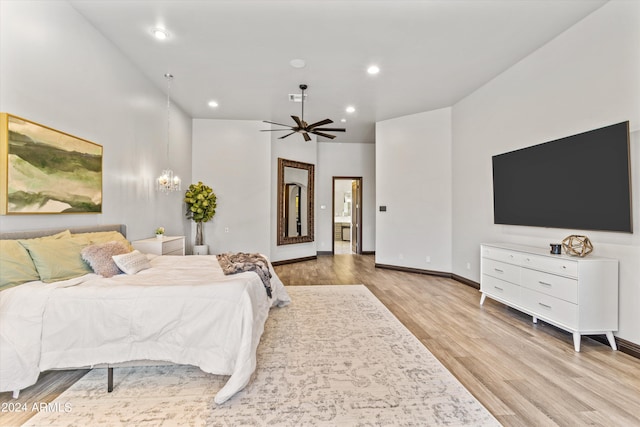 bedroom with recessed lighting, an inviting chandelier, baseboards, and wood finished floors