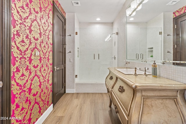 bathroom with a stall shower, visible vents, vanity, and wood finished floors