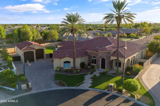 view of front of home with a tile roof, stone siding, decorative driveway, a residential view, and stucco siding