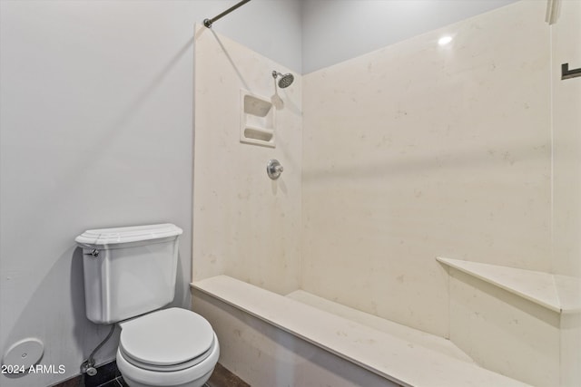 bathroom with walk in shower and toilet