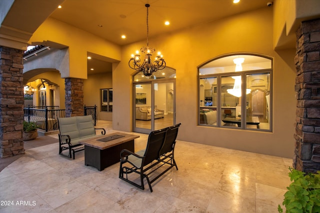 view of patio with an outdoor living space with a fire pit