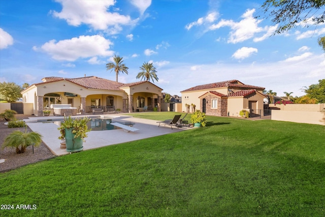 rear view of property with a lawn, a patio, a tile roof, fence, and stucco siding