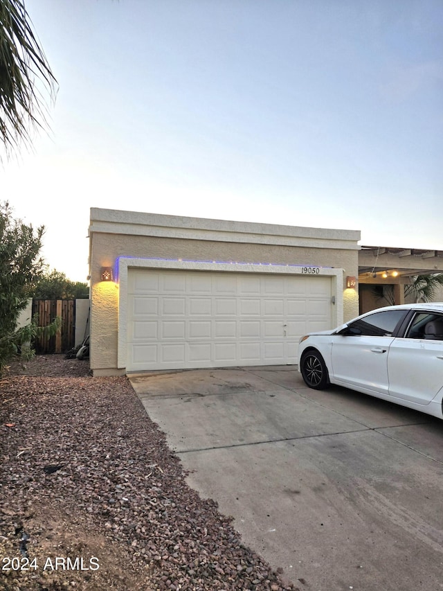 view of garage at dusk