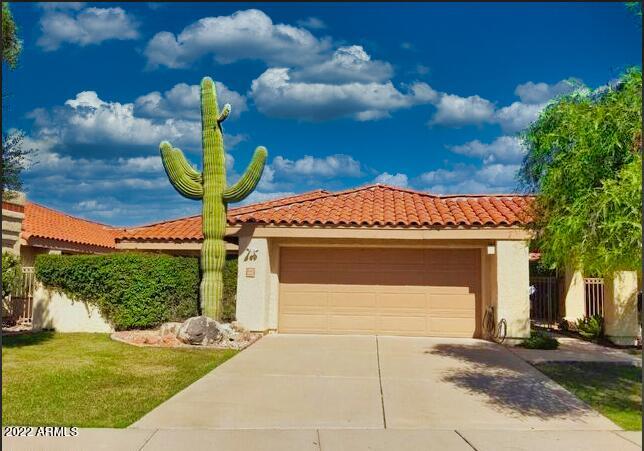 view of front of house with a garage and a front lawn