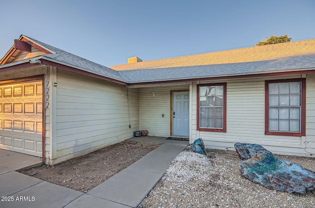 7222 W Maryland Ave, Glendale, AZ 85303 - view of exterior entry with a shingled roof and an attached garage