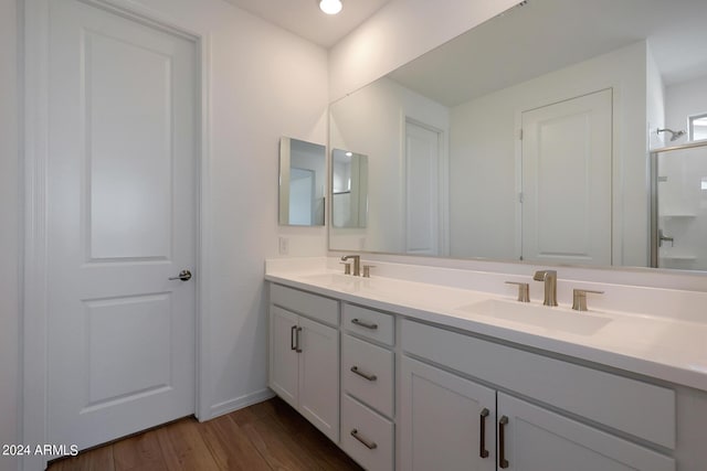 bathroom featuring vanity, a shower with shower door, and hardwood / wood-style floors