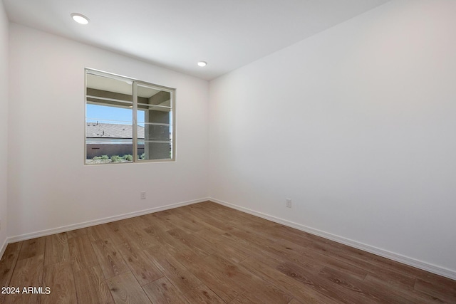 unfurnished room with hardwood / wood-style flooring