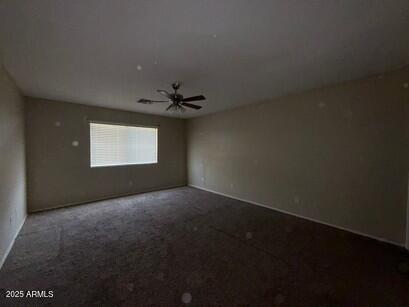 990 E Desert Rose Trl, San Tan Valley, AZ 85143 - carpeted empty room with a ceiling fan and baseboards