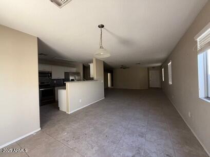 990 E Desert Rose Trl, San Tan Valley, AZ 85143 - unfurnished living room with baseboards and tile patterned flooring