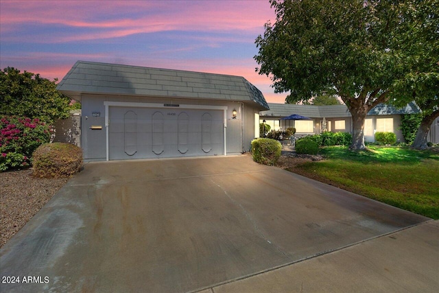 view of front of property with a lawn and a garage