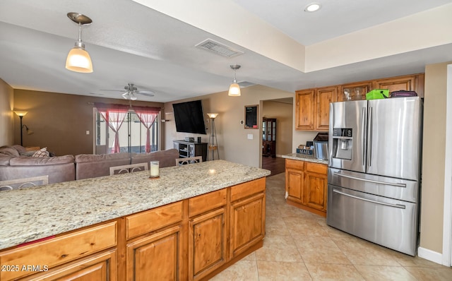 kitchen with visible vents, brown cabinets, stainless steel refrigerator with ice dispenser, and hanging light fixtures