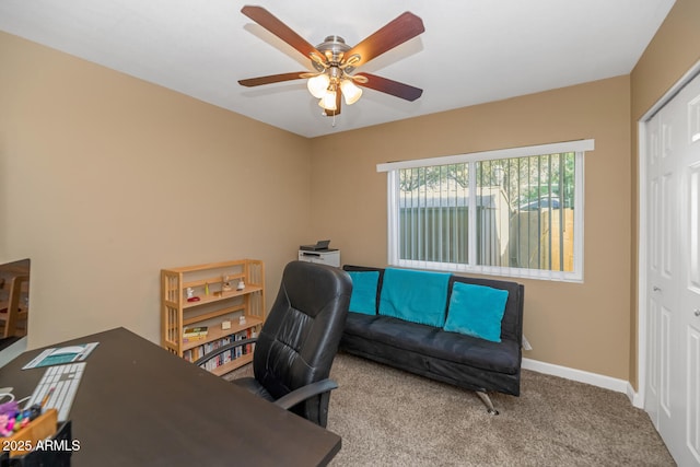 office area with baseboards, carpet floors, and ceiling fan