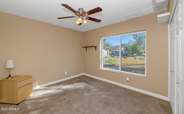 spare room featuring baseboards, carpet floors, and ceiling fan