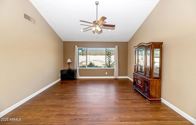 spare room featuring visible vents, wood finished floors, baseboards, and ceiling fan
