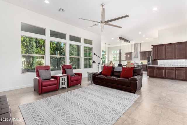 tiled living room with ceiling fan