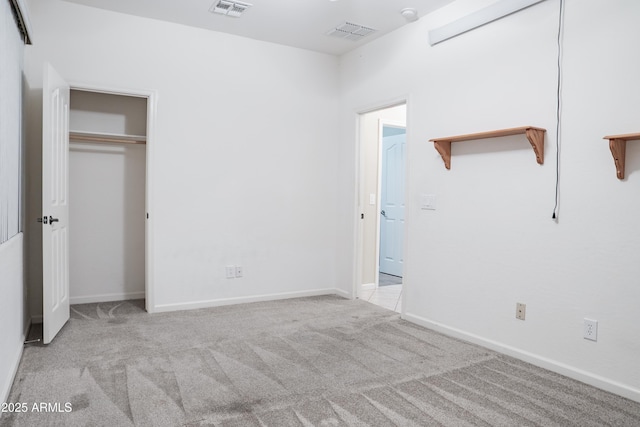 unfurnished bedroom featuring visible vents, carpet, and baseboards