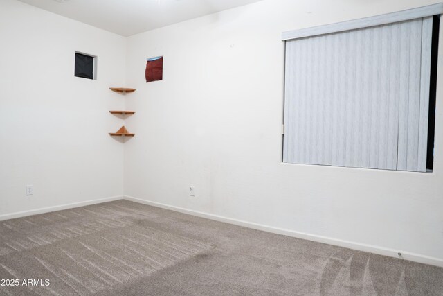 spare room with carpet floors and baseboards