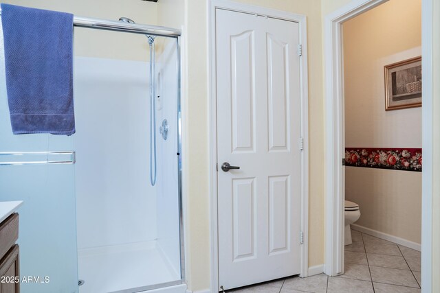 full bathroom with tile patterned flooring, a shower stall, toilet, vanity, and baseboards