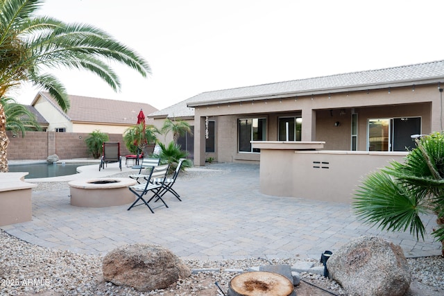 view of patio with fence and a fire pit