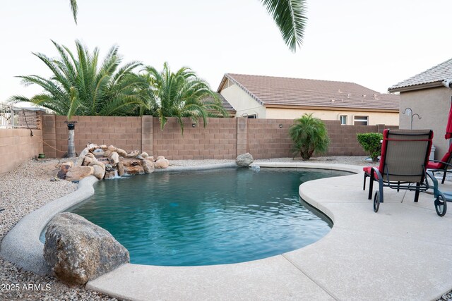view of swimming pool featuring a fenced backyard, a fenced in pool, and a patio area