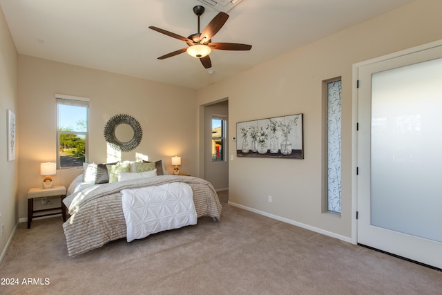 bedroom with ceiling fan and light carpet