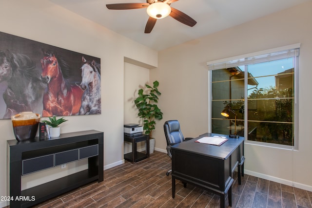 home office with ceiling fan and dark hardwood / wood-style floors