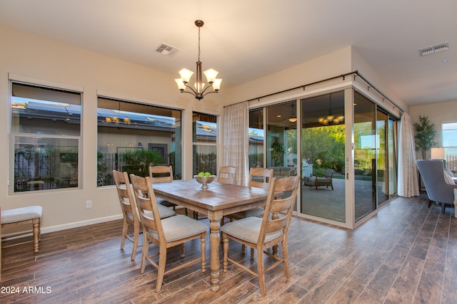 dining area with an inviting chandelier and dark hardwood / wood-style floors