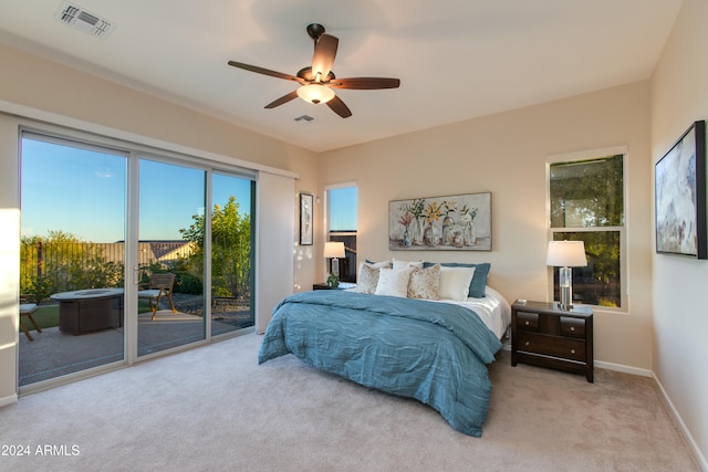 bedroom with access to exterior, light colored carpet, and ceiling fan