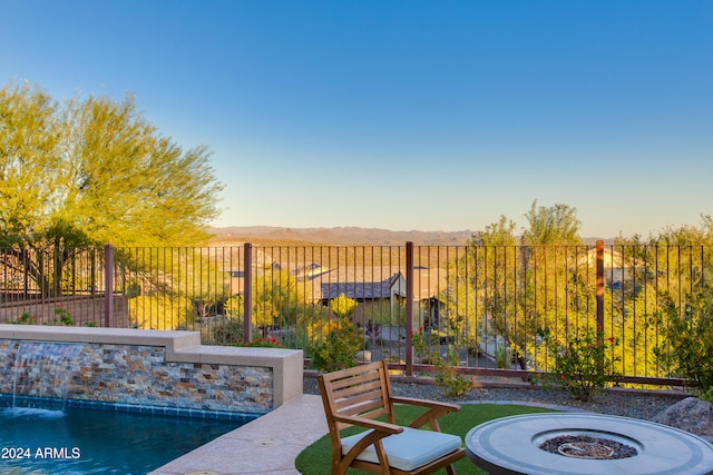 view of patio featuring a mountain view and a fire pit