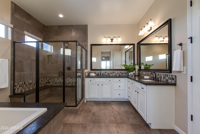 bathroom with vanity and shower with separate bathtub