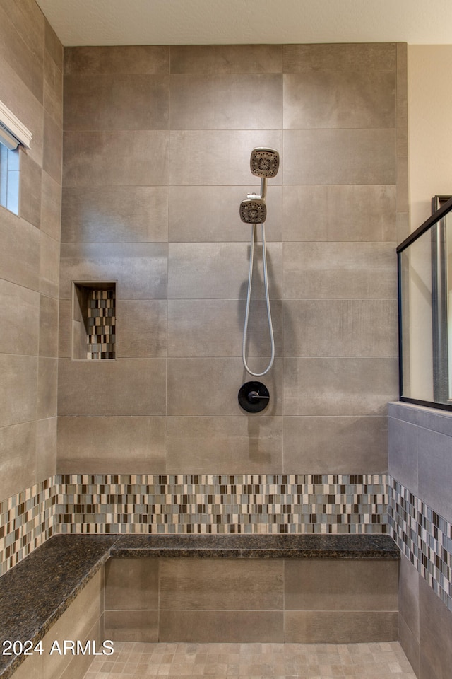 bathroom with tiled shower