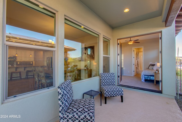 living area with carpet flooring and ceiling fan